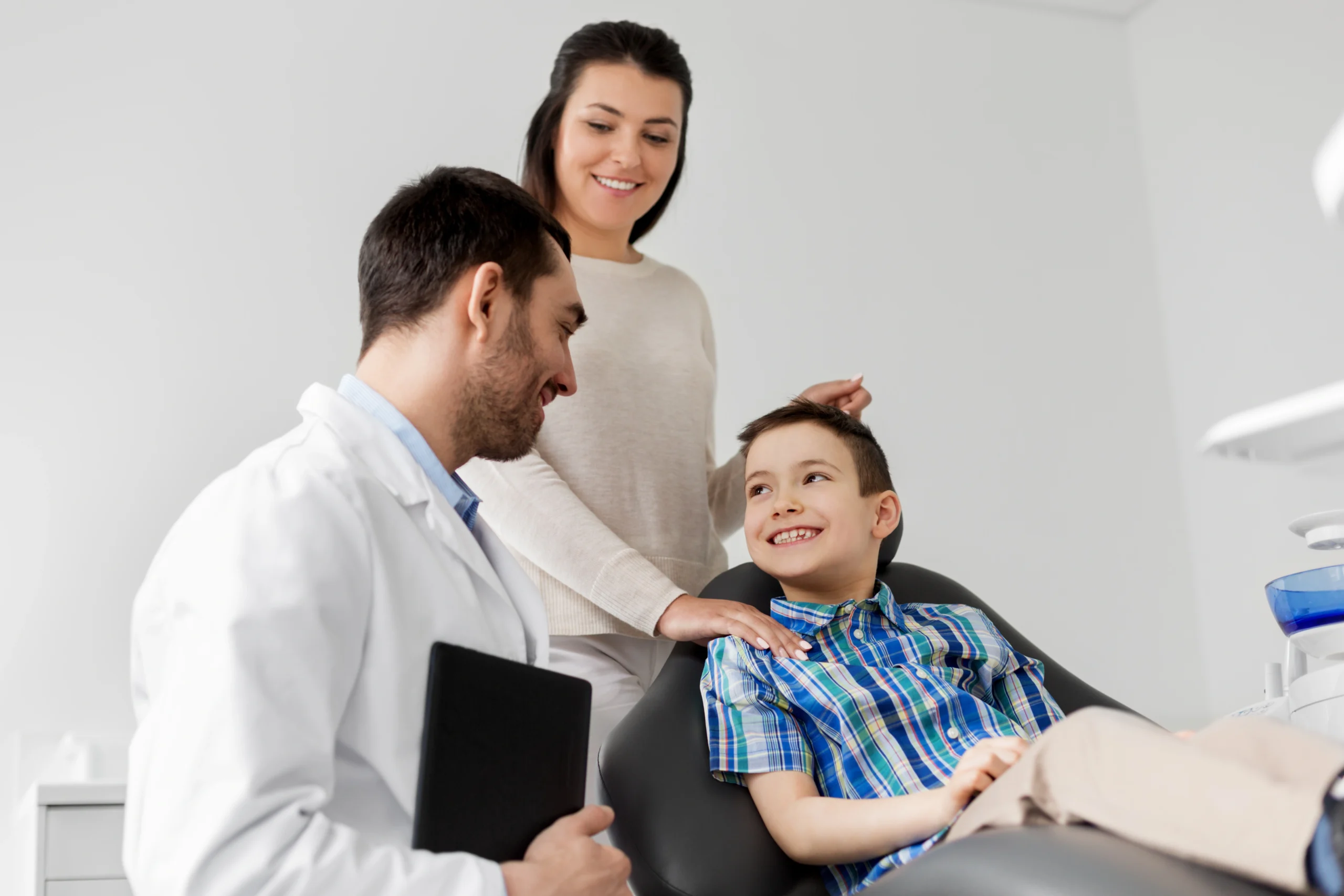 Family dentist in Indianapolis with young patient and parent at PrimeCare Family Dental